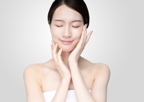 女性が顔に手を当てている画像